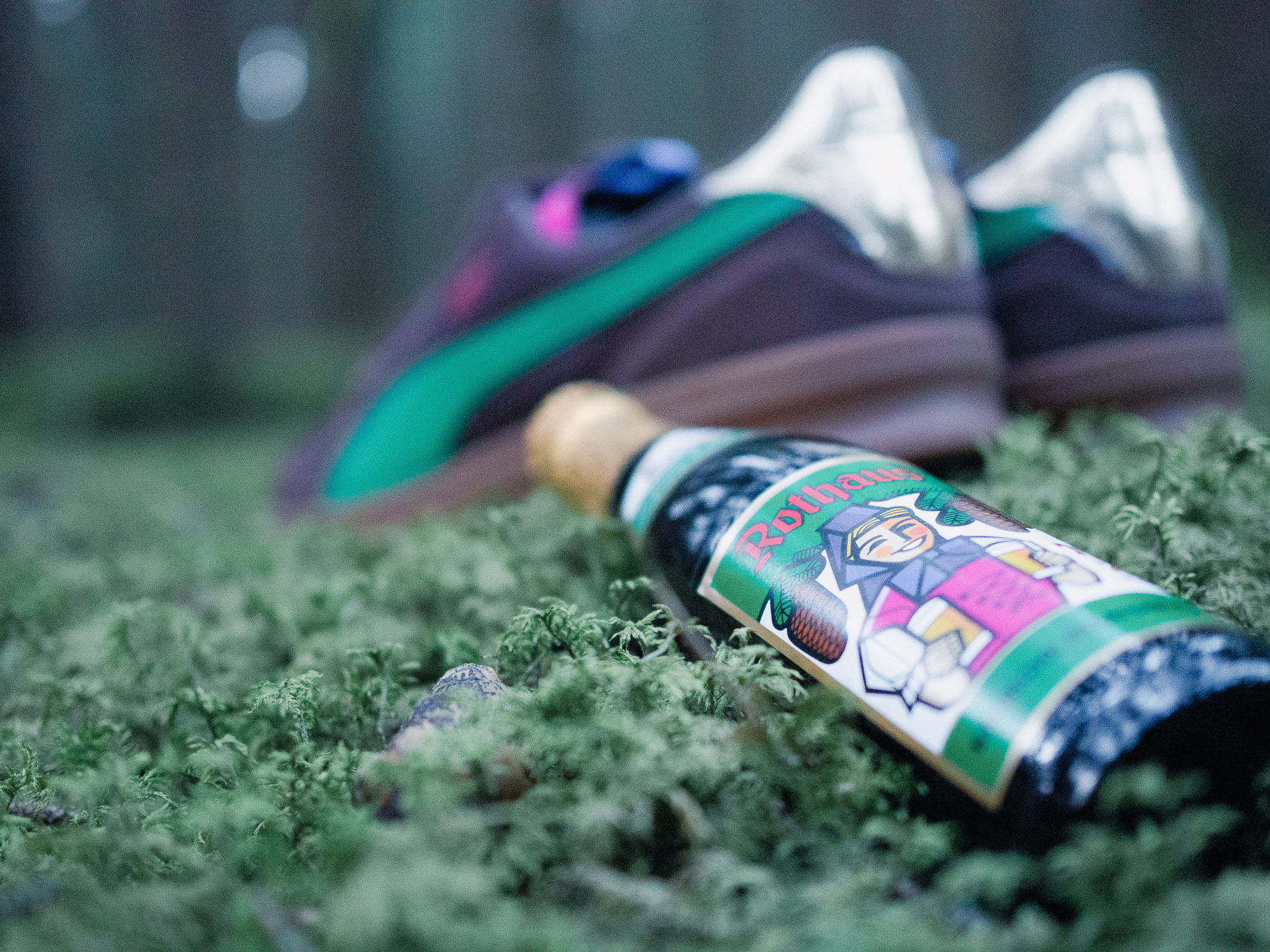 PUMA x Rothaus Indoor Tannenzäpfle sneaker from behind with a Rothaus Tannenzäpfle bottle lying next to it