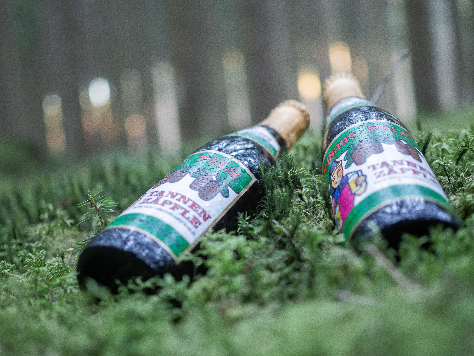 Two Rothaus Tannenzäpfle bottles in the moss